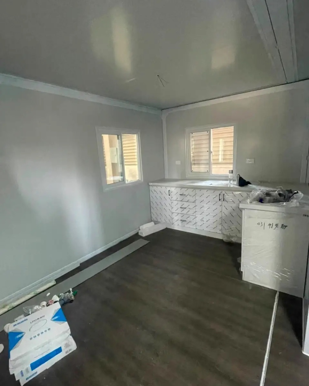 Bright modular-home living space with finished floors, windows, and interior trim