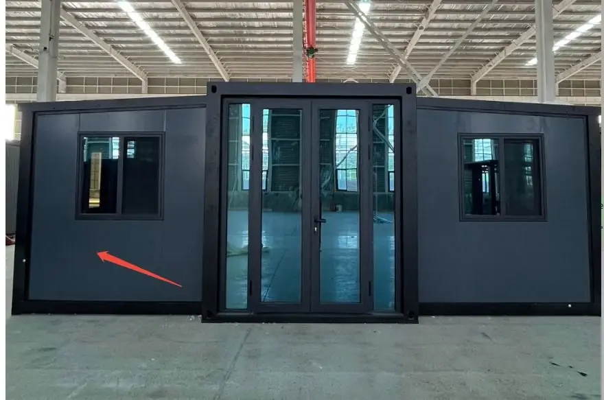 Dark gray expandable modular unit with glass doors displayed inside a warehouse